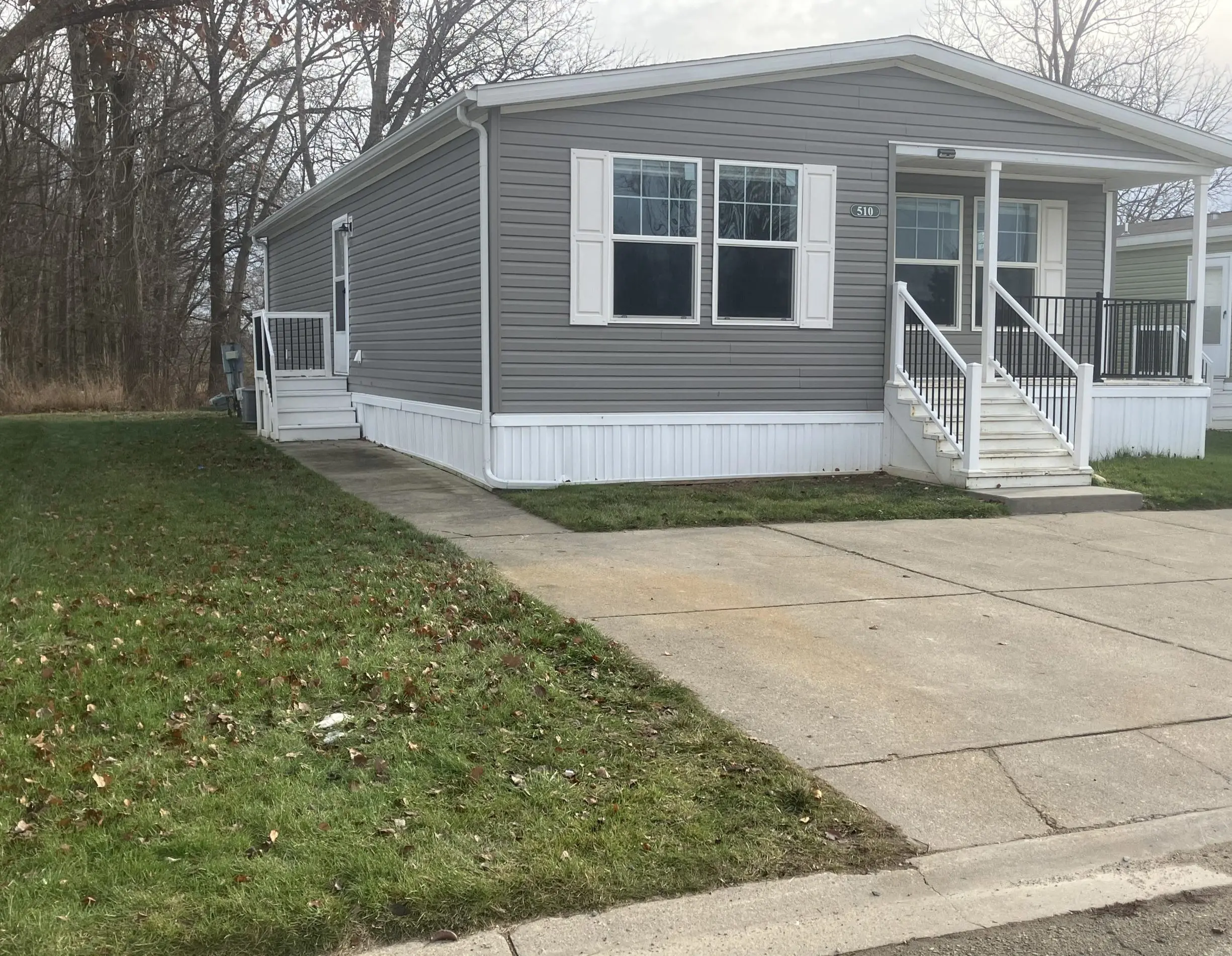 manufactured home with driveway and lawn Morrice, Michigan